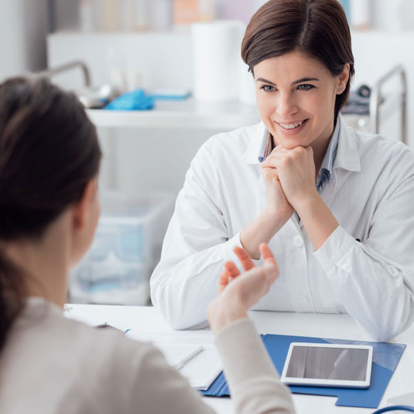 An oral surgeon consulting with a patient