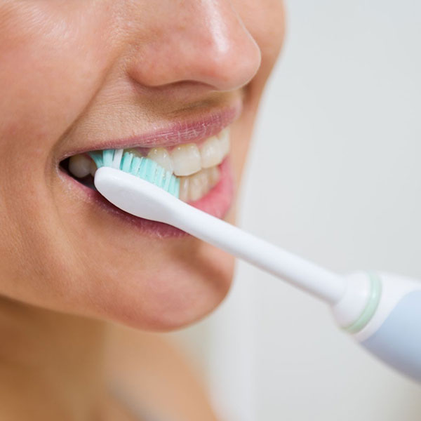 An oral surgery patient brushes teeth