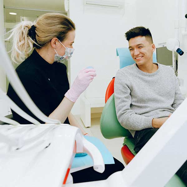 An oral surgery patient in consultation with an oral surgeon